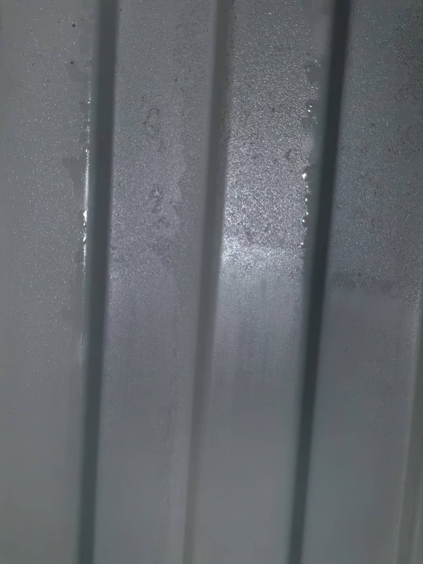 Water droplets across the interior wall of a shipping container