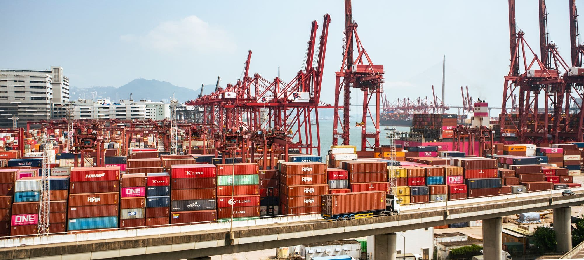 Quayside cranes and container stacks at a Hong Kong terminal